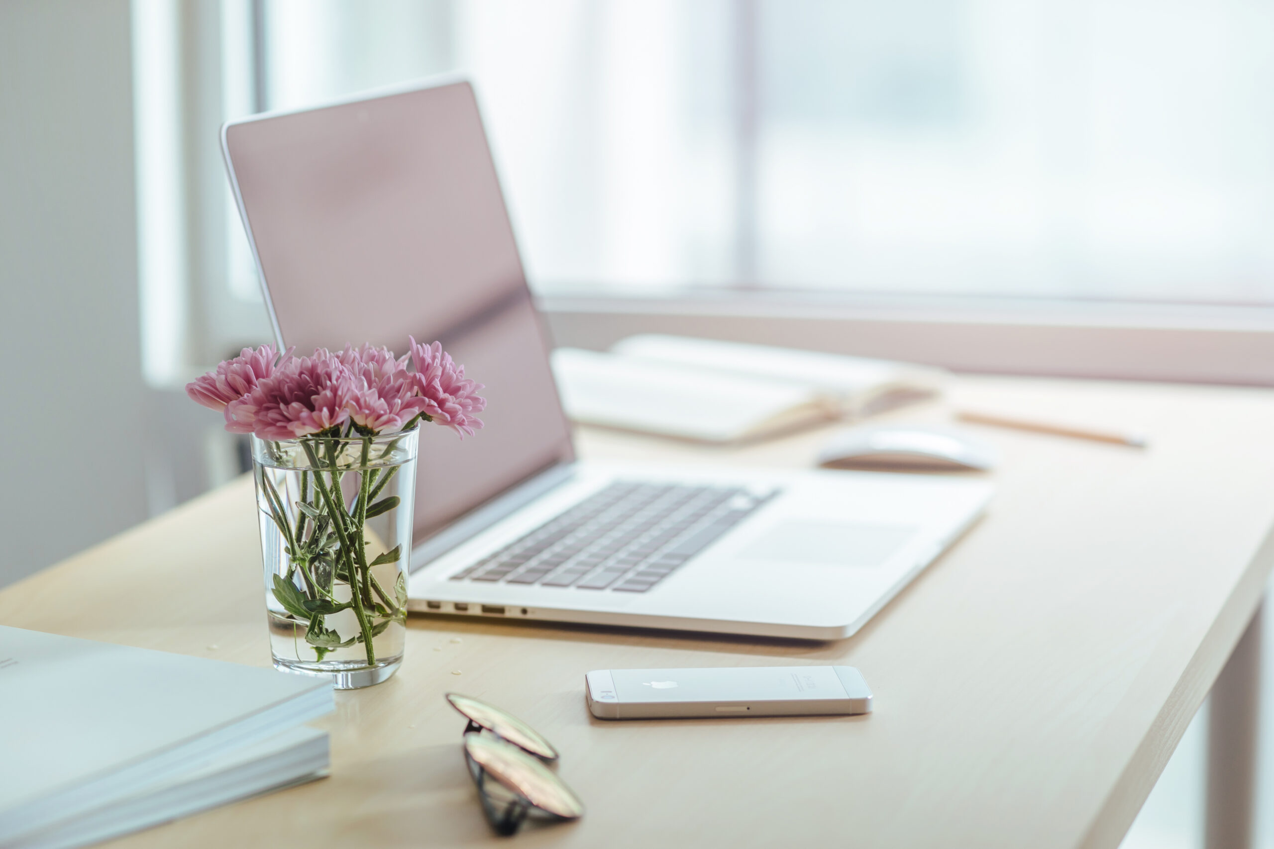 Pink Flowers and a laptop on a desk